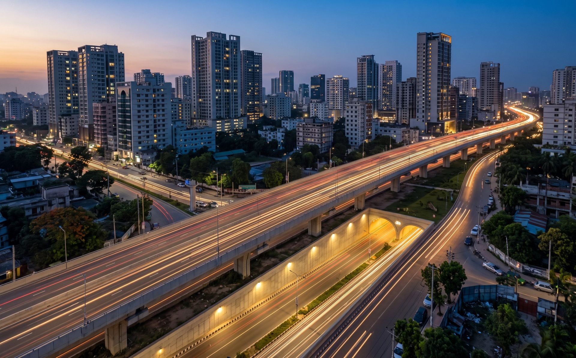 Dhaka skyline with an elevated expressway and tunnel entrance at dusk